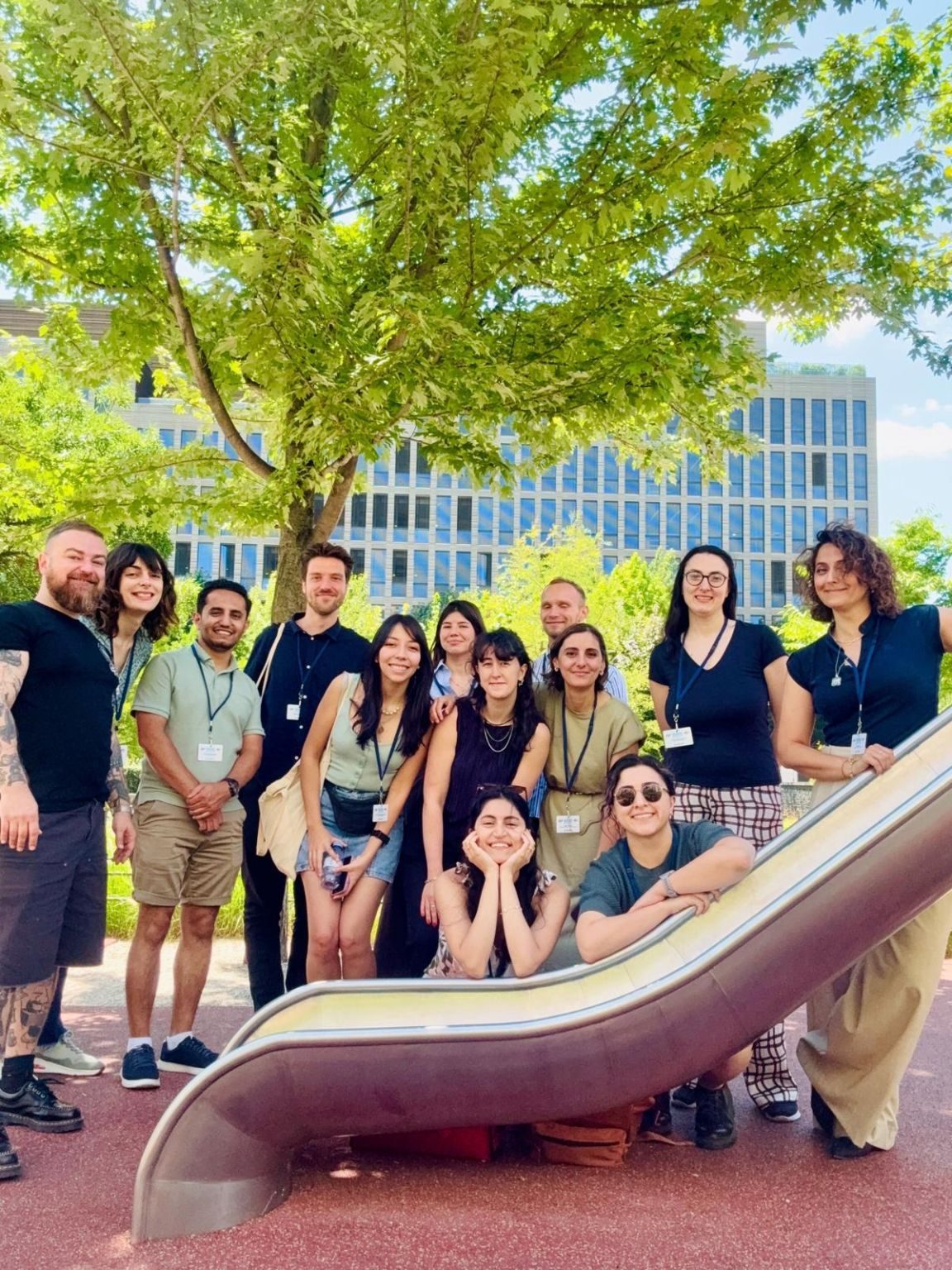 Tuba Bircan with members of the AIMS Lab, smiling around a slide in a park in Paris